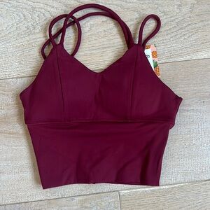 NEW WITH TAGS athletic top with cute criss cross detail, bra cups, lined XS.